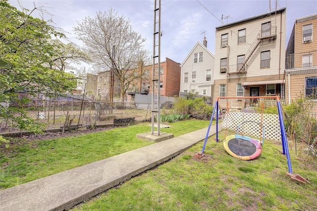 surrounding community featuring a lawn, fence, and a residential view