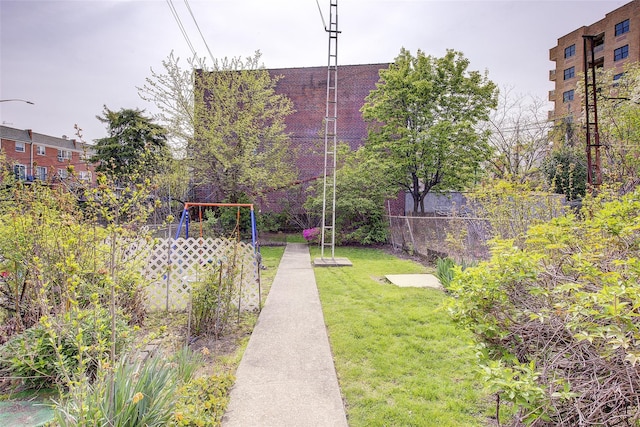 view of home's community featuring a lawn and fence