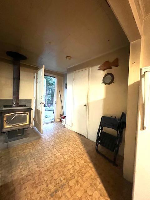 50 Lieper St, Huntington Station, NY 11746 - unfurnished living room featuring a wood stove