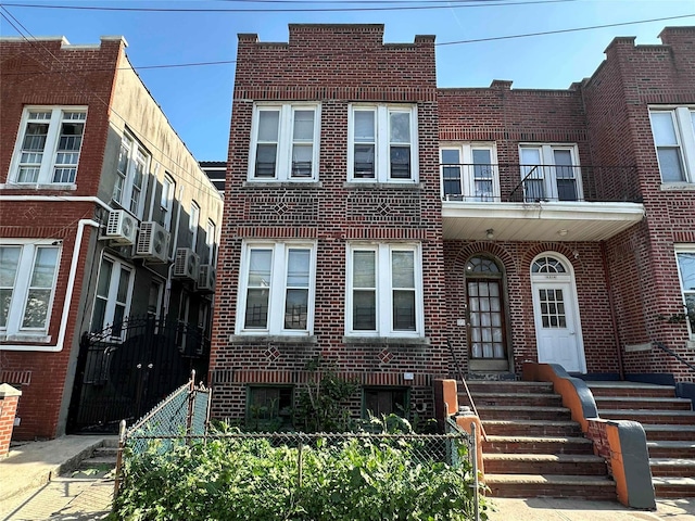multi unit property featuring brick siding and fence