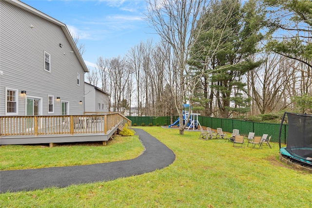 93 Wood Ave, Monticello, NY 12701 - view of yard featuring a playground, fence, a trampoline, and a wooden deck