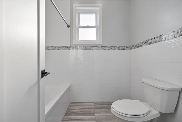 93 Wood Ave, Monticello, NY 12701 - bathroom with bathtub / shower combination, toilet, and tile walls