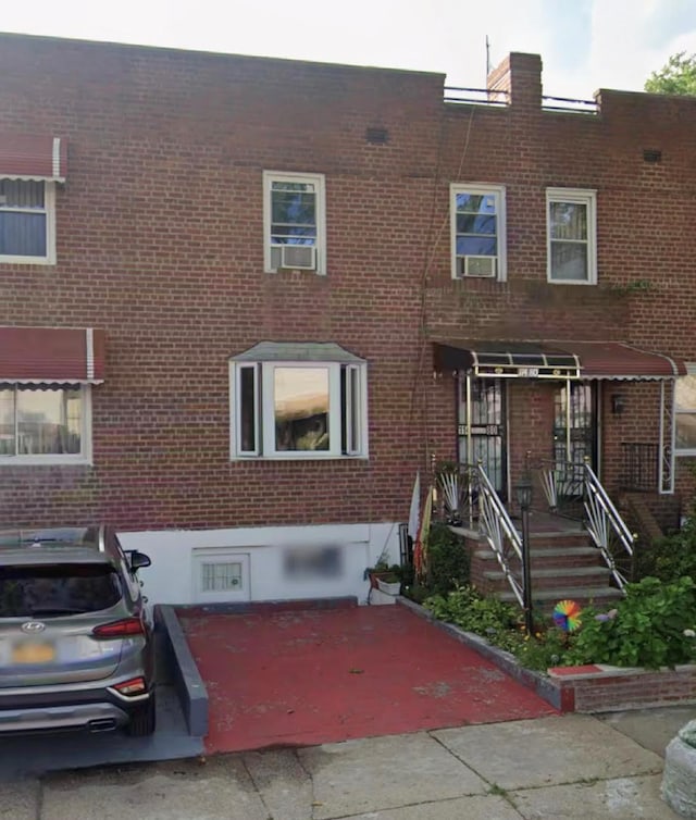 townhome / multi-family property with brick siding