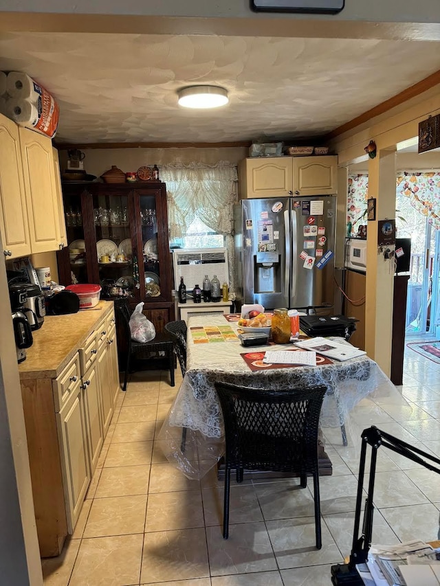 kitchen with light countertops, stainless steel fridge, light tile patterned floors, and cooling unit