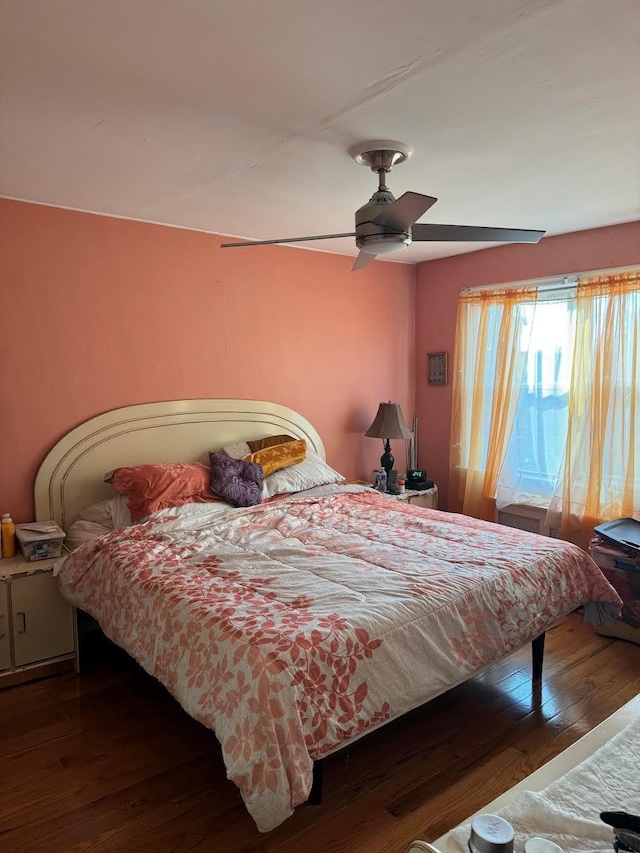 bedroom featuring wood-type flooring and a ceiling fan