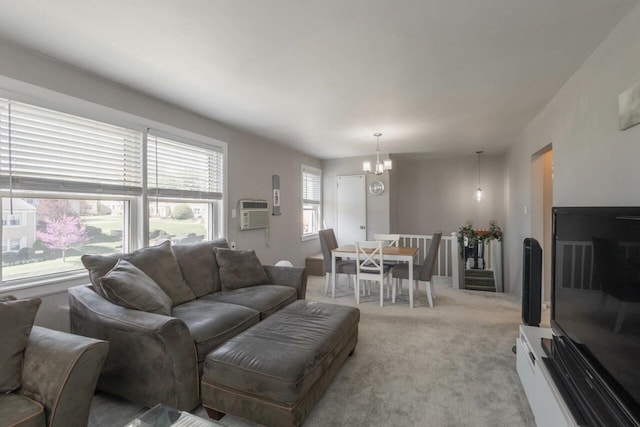 living area with an inviting chandelier, a wall mounted AC, and light carpet