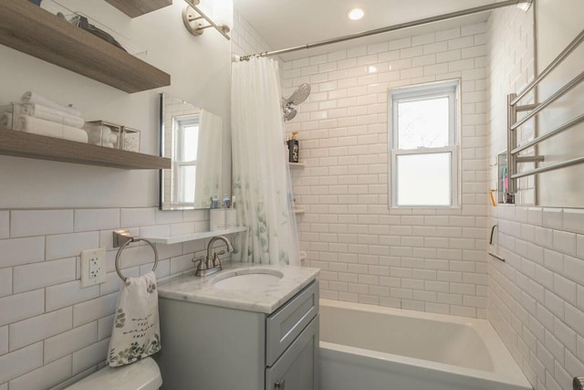 bathroom featuring vanity, plenty of natural light, toilet, and shower / bath combination with curtain