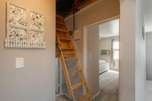 staircase with a wall mounted air conditioner and carpet