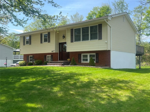 split foyer home with brick siding and a front yard