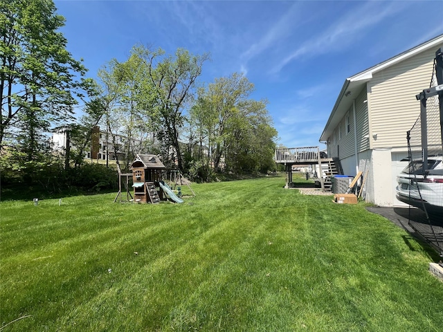 view of yard with stairs, a playground, and a deck