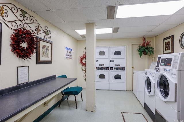 community laundry room with light floors, independent washer and dryer, stacked washer / dryer, and visible vents