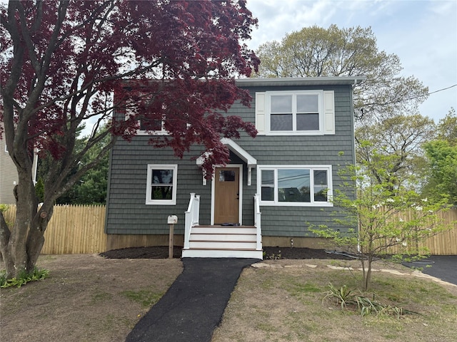 view of front facade featuring fence