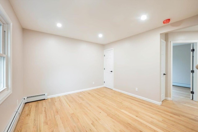 105 Phyllis Dr, Lindenhurst, NY 11757 - spare room with baseboards, a baseboard radiator, light wood finished floors, and recessed lighting