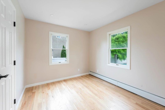105 Phyllis Dr, Lindenhurst, NY 11757 - unfurnished room with baseboards, a baseboard radiator, and wood finished floors