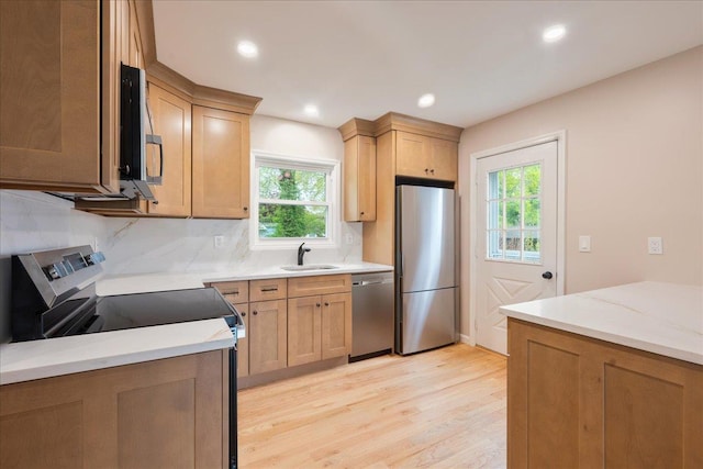 105 Phyllis Dr, Lindenhurst, NY 11757 - kitchen with a sink, stainless steel appliances, light wood-type flooring, recessed lighting, and backsplash