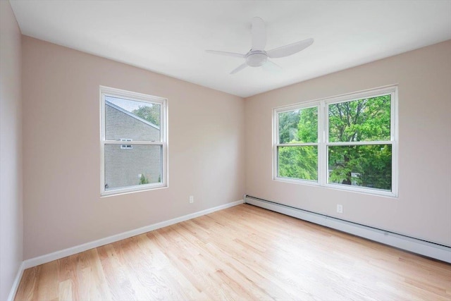 105 Phyllis Dr, Lindenhurst, NY 11757 - empty room featuring baseboard heating, wood finished floors, baseboards, and ceiling fan