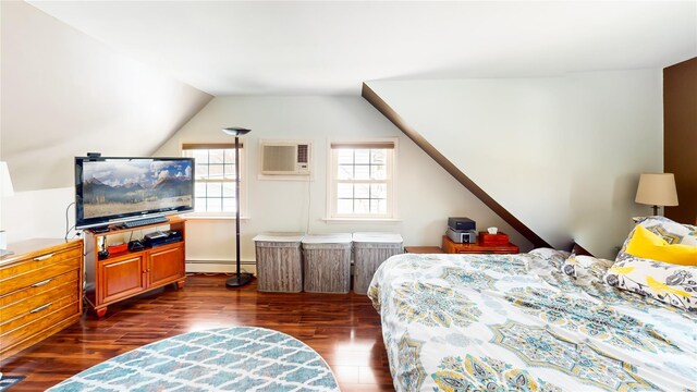 bedroom featuring vaulted ceiling, baseboard heating, dark wood-type flooring, and a wall mounted air conditioner