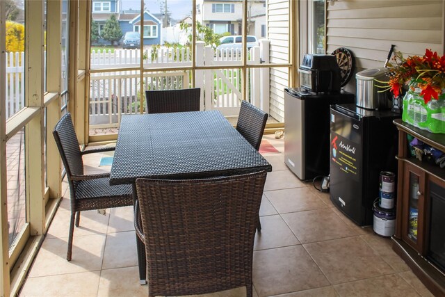 sunroom with outdoor dining area