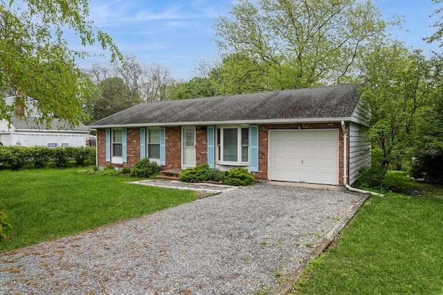 900 Cedar Dr, Southold, NY 11971 - single story home with brick siding, an attached garage, gravel driveway, a front lawn, and a shingled roof