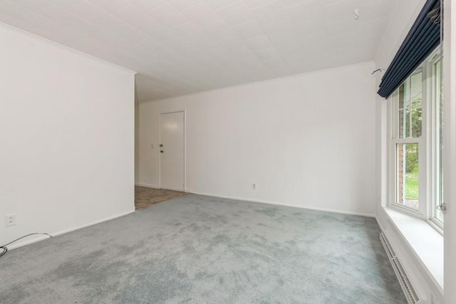 900 Cedar Dr, Southold, NY 11971 - spare room featuring healthy amount of natural light, carpet, crown molding, and baseboards