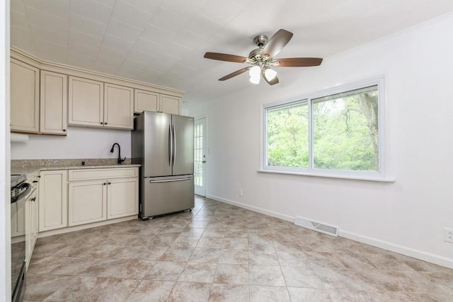 900 Cedar Dr, Southold, NY 11971 - kitchen featuring freestanding refrigerator, cream cabinets, black electric range oven, and a ceiling fan