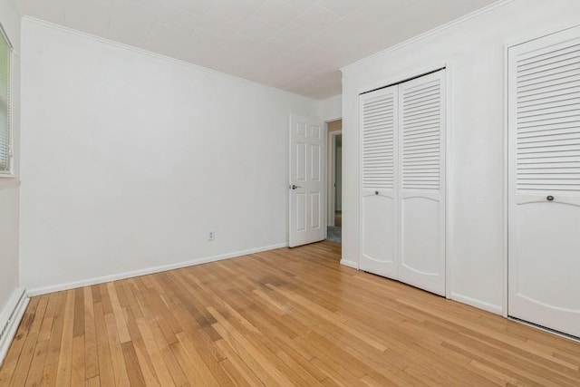 900 Cedar Dr, Southold, NY 11971 - unfurnished bedroom featuring light wood-style flooring, crown molding, baseboards, and a baseboard radiator