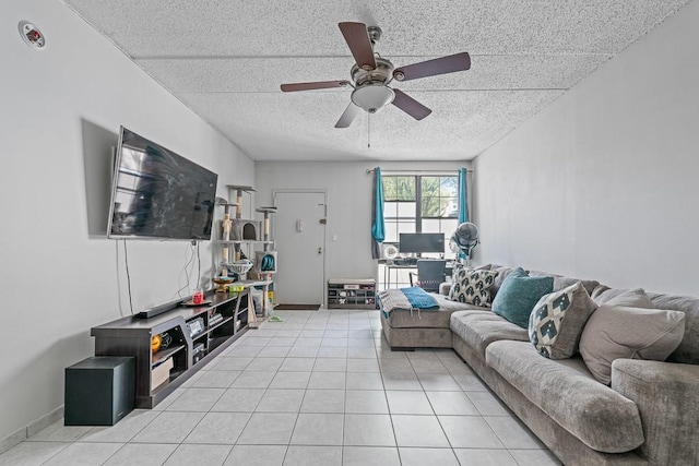living area with light tile patterned floors, a ceiling fan, and a textured ceiling
