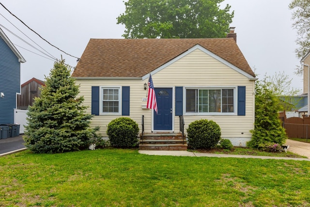 view of front of house with a chimney, roof with shingles, and entry steps