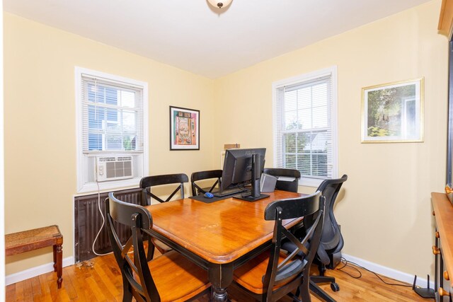 office featuring baseboards, light wood-style floors, and plenty of natural light