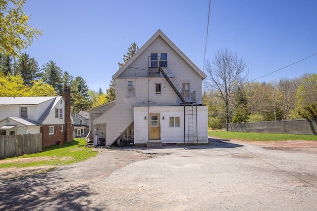 back of house with fence and entry steps