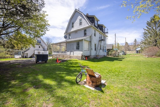 rear view of house featuring a yard