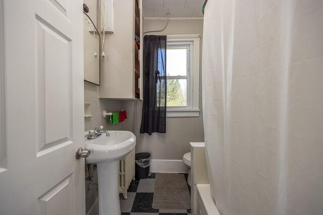 full bathroom with a sink, a bathing tub, toilet, tile patterned floors, and curtained shower