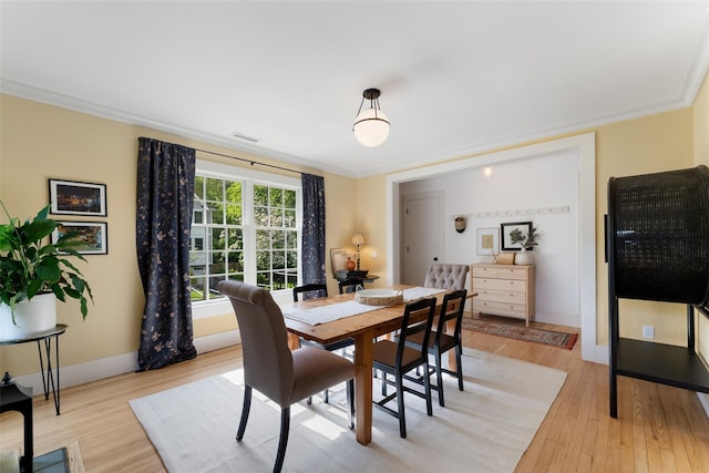 dining room with light wood-style floors and baseboards