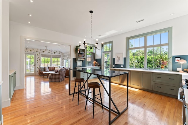 kitchen featuring gray cabinets, light wood-type flooring, a chandelier, open floor plan, and recessed lighting