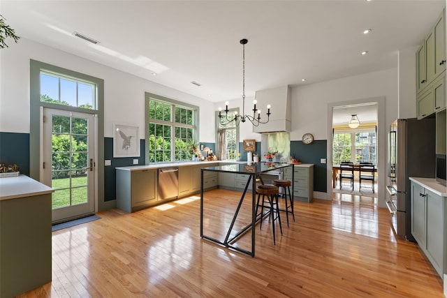 kitchen featuring stainless steel appliances, a chandelier, plenty of natural light, light wood-type flooring, and recessed lighting