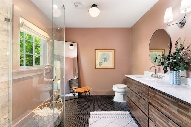 full bathroom featuring toilet, a stall shower, vanity, baseboards, and tile patterned flooring