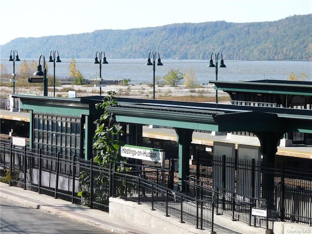 surrounding community featuring fence and a water and mountain view