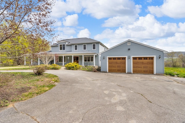 view of front of house featuring a porch, a garage, and driveway