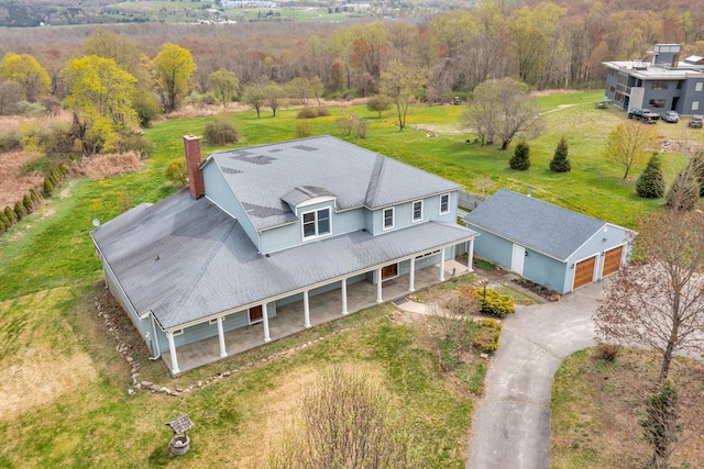 drone / aerial view featuring a view of trees