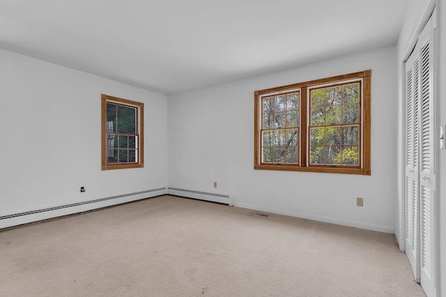 interior space featuring baseboards, light carpet, a closet, and visible vents