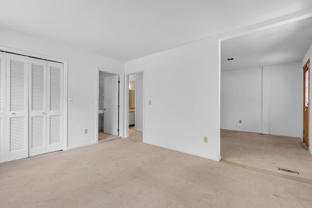 unfurnished bedroom with baseboards, carpet flooring, and visible vents