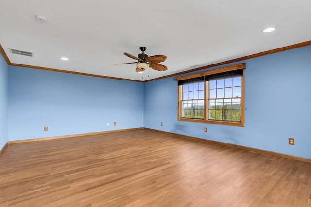 empty room featuring crown molding, a ceiling fan, and visible vents