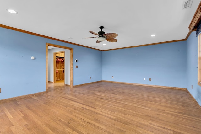 empty room featuring baseboards, a ceiling fan, light wood-style flooring, and visible vents