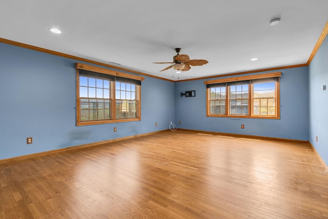 unfurnished room featuring baseboards, ceiling fan, ornamental molding, and wood finished floors