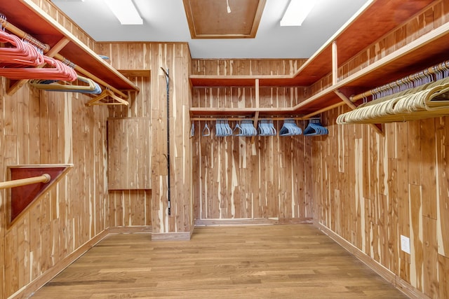 walk in closet featuring wood finished floors
