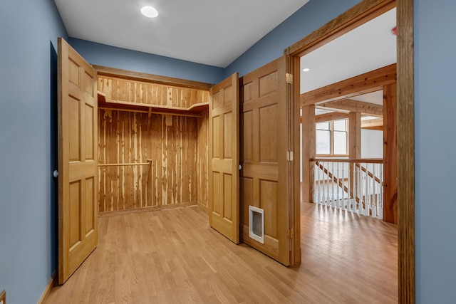 mudroom featuring wood walls and light wood-style flooring