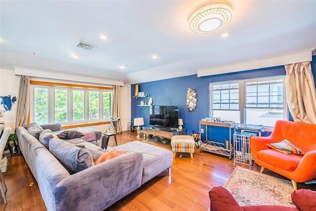 living room featuring visible vents, recessed lighting, and wood finished floors
