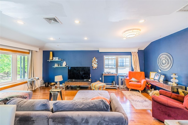 living room with visible vents, recessed lighting, and plenty of natural light