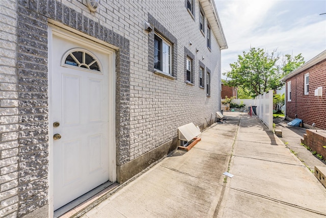 doorway to property with brick siding