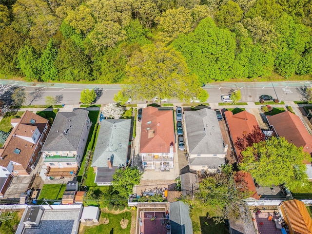 aerial view featuring a residential view and a wooded view